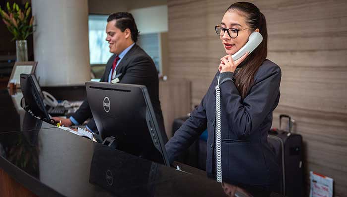 Receptionists at a hotel front desk